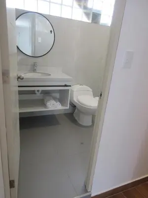 a bathroom with a sink and a toilet and a mirror at Venue Apartments in Lima