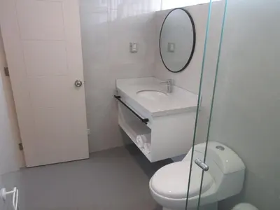 a bathroom with a toilet and a sink and a mirror at Venue Apartments in Lima