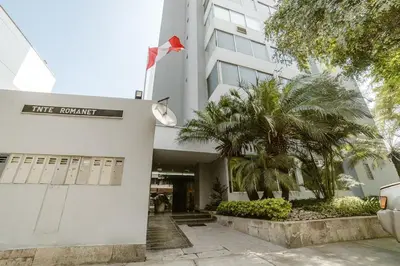 a building with a sign on the front of it at Romanet - Depa Premium con Vista al Golf in Lima