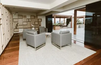 a living room with couches and a table and chairs at Alcanfores - Tu Escapada Urbana Perfecta in Lima