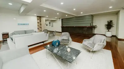 a living room with a couch and a piano at Alcanfores - Tu Escapada Urbana Perfecta in Lima