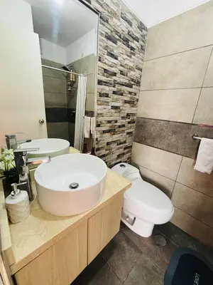 a bathroom with a white sink and a toilet at Apartamento moderno en San Miguel in Lima