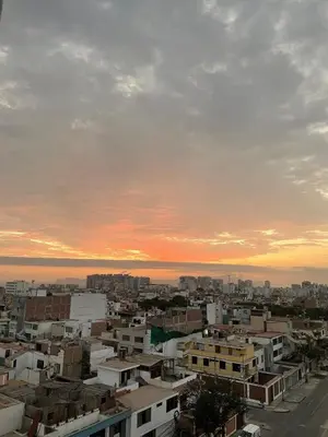 a view of a city at sunset at Apartamento moderno en San Miguel in Lima