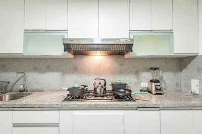 a kitchen with a stove with two pots on it at Benavides - Amplio departamento funcional de 3 hab en Av Principal in Lima