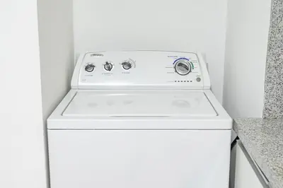a white washer and dryer in a white room at Benavides - Amplio departamento funcional de 3 hab en Av Principal in Lima