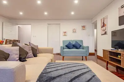 a living room with two couches and a television at Benavides - Amplio departamento funcional de 3 hab en Av Principal in Lima