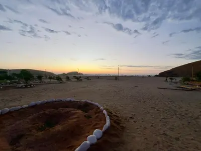 a view of a beach with the sun setting at Beach house Sol Mar y Relax in Cerro Azul