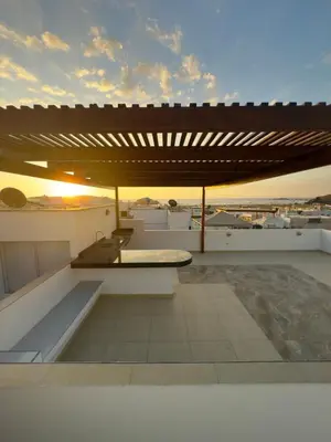 a rooftop patio with a table and a bench at Beach house Sol Mar y Relax in Cerro Azul