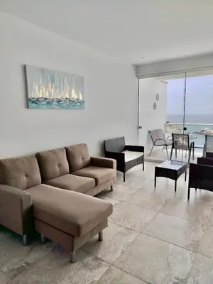 a living room with a couch and chairs and a table at Excellent view of Mar San Bartolo in San Bartolo