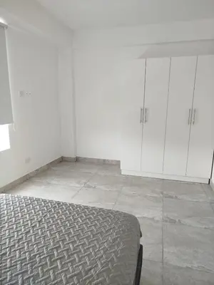 a white room with a bed and white cabinets at Excellent view of Mar San Bartolo in San Bartolo