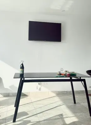 a black table with a tv on a white wall at Excellent view of Mar San Bartolo in San Bartolo