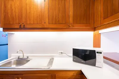 a microwave sitting on a kitchen counter next to a sink at GRM308 Bright 2BR with BIG Terrace in Heart of Miraflores in Lima