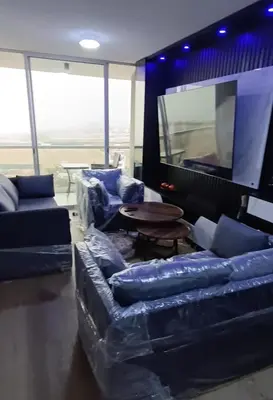 a living room with couches and a flat screen tv at Dpto de Playa Miramar San Bartolo in San Bartolo