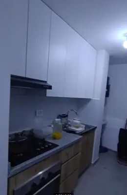 a kitchen with white cabinets and a counter top at Dpto de Playa Miramar San Bartolo in San Bartolo