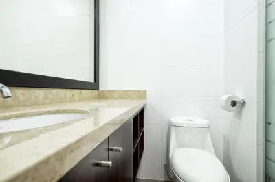 a bathroom with a sink and a toilet at Wasi Apartment Pardo in Lima