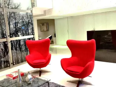 two red chairs in a room with a fireplace at Peru Rent Apart com pe in Lima
