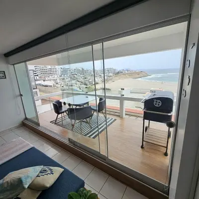 a room with a balcony with a table and chairs at Departamento amplio en punta hermosa frente al mar in Punta Hermosa