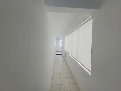 a hallway with white walls and a white tile floor at Departamento amplio en punta hermosa frente al mar in Punta Hermosa