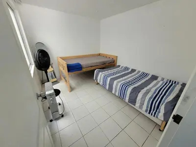 a small bedroom with a bed and a window at Departamento amplio en punta hermosa frente al mar in Punta Hermosa