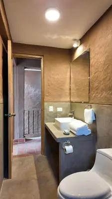 a bathroom with a toilet and a sink and a mirror at Casa Catahuasi , Sacred Valley ,Urubamba,Cusco, Peru in Urubamba