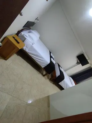 a bedroom with two twin beds in a room at Kuntur House Machupicchu in Machu Picchu