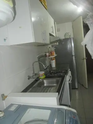 a small kitchen with a sink and a refrigerator at 10p dpto in Lima