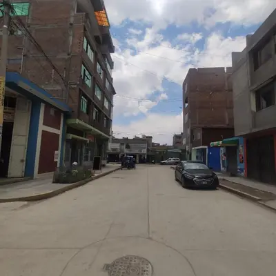 a street with a car parked in a parking lot at Depawanka habitacion amoblado in Huancayo