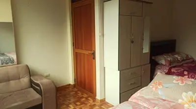 a bedroom with a dresser and a bed and a chair at Depawanka habitacion amoblado in Huancayo