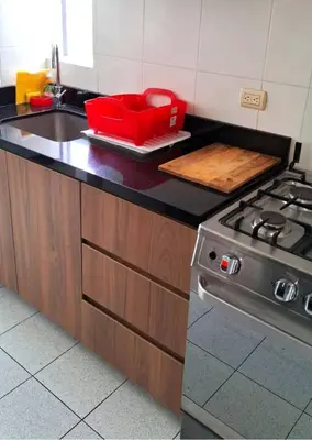 a kitchen with a stove and a red container on the counter at El Derby 511 Aparts de 3 Dorm con Aire Acondicionado in Lima