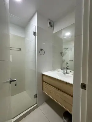 a white bathroom with a shower and a sink at molero in Lima