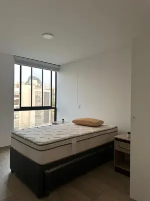 a large bed in a room with a large window at molero in Lima