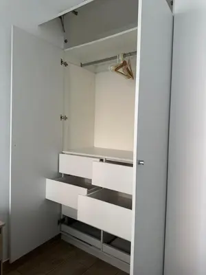 a closet with white walls and white drawers at molero in Lima