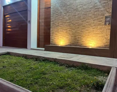 a pair of lights on the side of a building at Huacachina Lagoon House in Ica