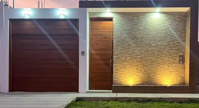 two wooden doors on the side of a house at Huacachina Lagoon House in Ica