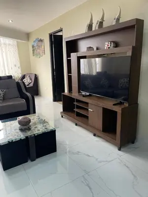 a living room with a large entertainment center with a television at Mirador Vip Apartment in Cusco