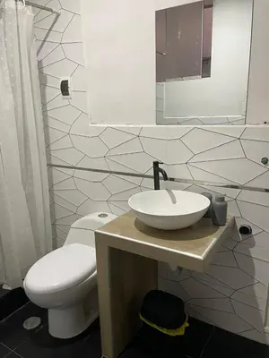 a bathroom with a white toilet and a sink at Mirador Vip Apartment in Cusco