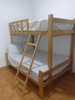 a bunk bed with a ladder in a room at Casa, Playa el pasamayito sur de asia in Asia
