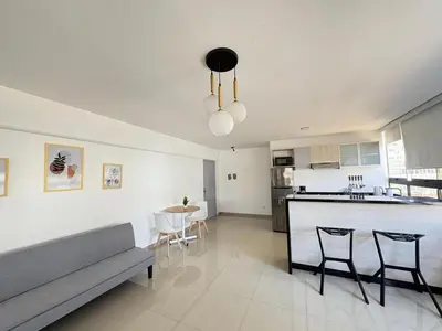 a living room and kitchen with a couch and a counter at Apartment in Lima in Lima