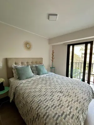 a bedroom with a large bed and a large window at Art28 Studio Apartment in Lima