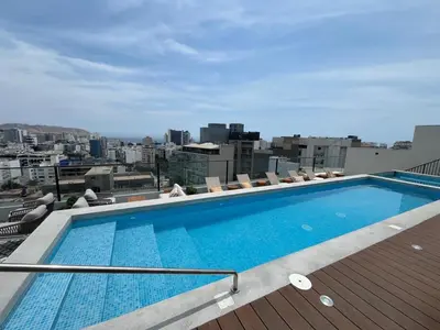 a swimming pool on the roof of a building at Art28 Studio Apartment in Lima