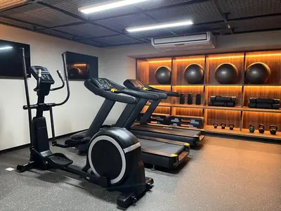 a room with a gym with a treadmill and weights at Art28 Studio Apartment in Lima