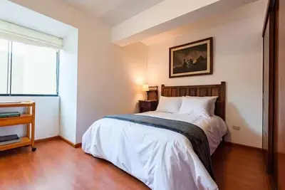 a bedroom with a bed and a window at M701 Malecón View Apartment 3 BDR in Lima