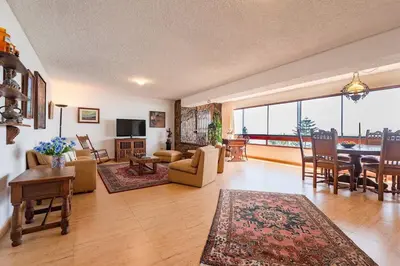 a living room with a table and a dining room at M701 Malecón View Apartment 3 BDR in Lima