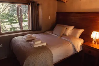 a bedroom with a bed with two towels on it at Stunning 1BR House in Camino Real in Urubamba