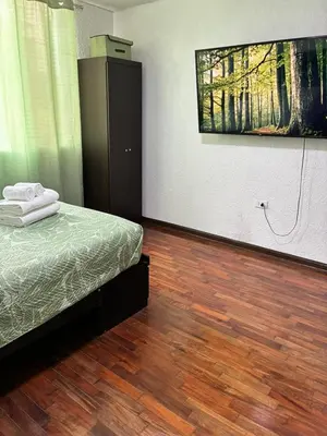a bedroom with a bed and a wooden floor at Green Love in Lima