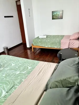 two beds sitting in a room with at Green Love in Lima