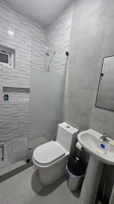 a bathroom with a toilet and a shower and a sink at Casa de Playa de Estreno in Cerro Azul