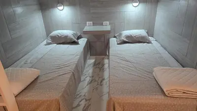 two twin beds in a small room with at Casa de Playa de Estreno in Cerro Azul