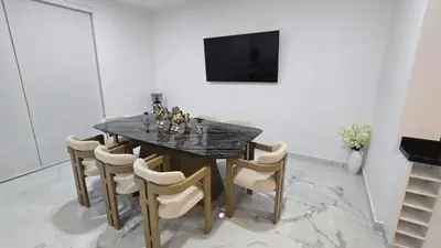 a dining room with a black marble table and chairs at Casa de Playa de Estreno in Cerro Azul