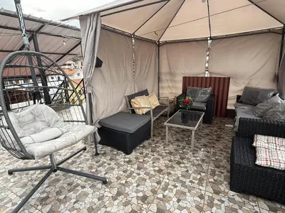 a tent with a couch and chairs in it at Chabela Host in Cusco